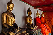 Bangkok Wat Pho, Buddha gilded statues lined in the double cloister enclosing the ubosot. 